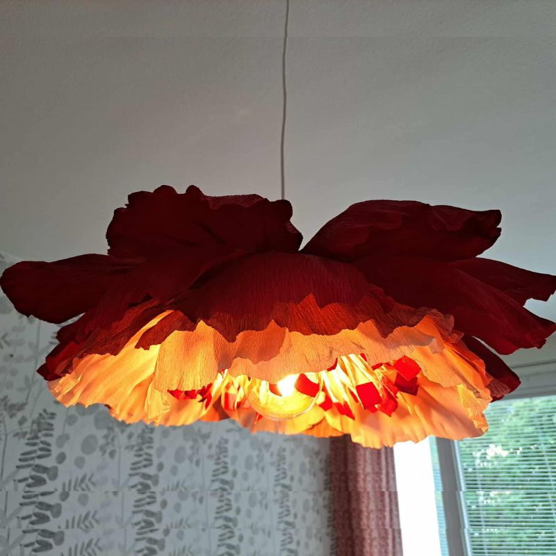 Mellan blomlampa i röda nyanser